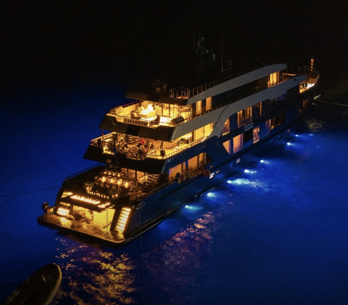 Jasmine yacht illuminated on the Red Sea at night