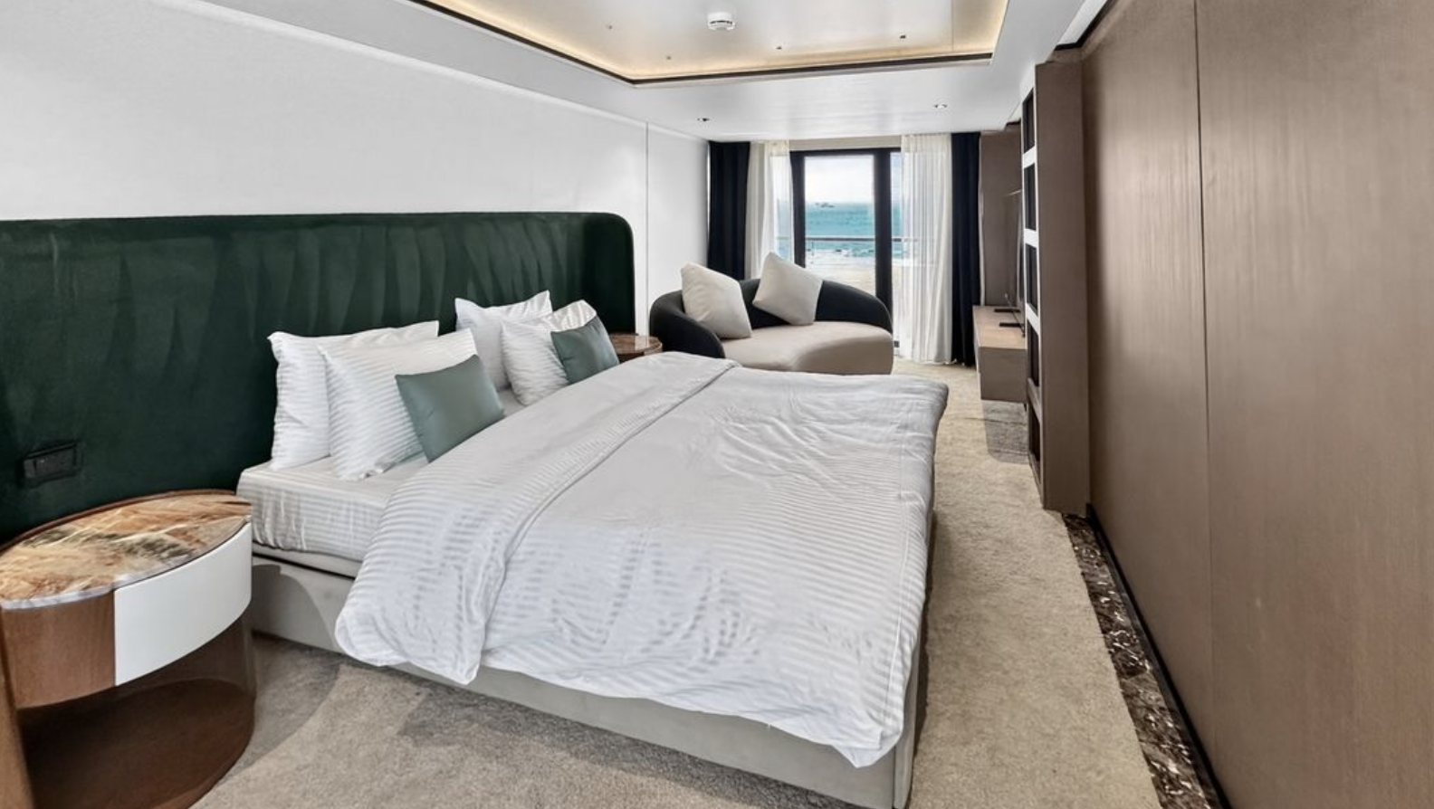 Jasmine suite with a queen bed and floor-to-ceiling sea views